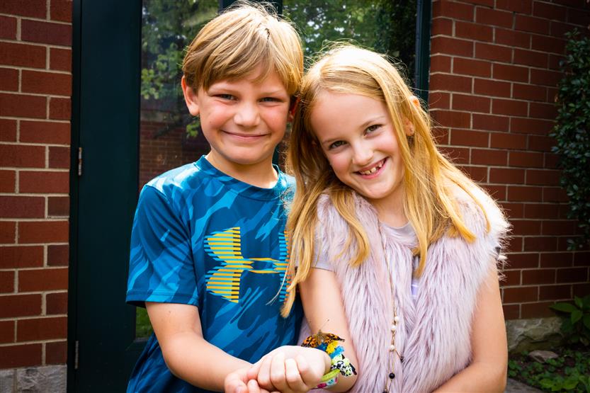 A boy and girl smile